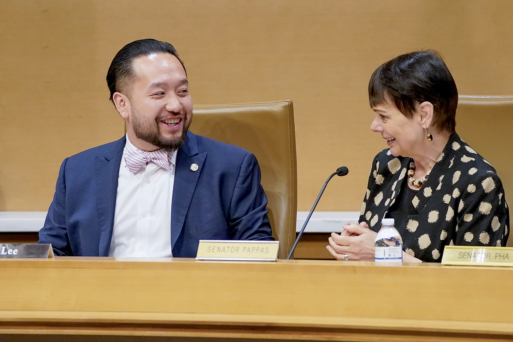 Rep. Fue Lee and Sen. Sandra Pappas chat before convening a joint hearing of the House and Senate Capital Investment committees May 14. (Photo by Michele Jokinen)